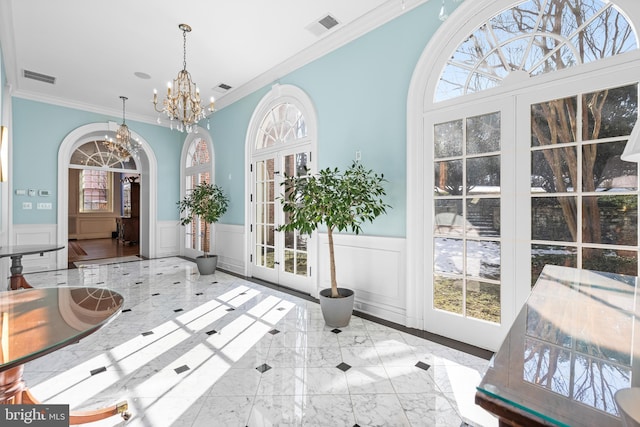 entryway with a notable chandelier, french doors, visible vents, and marble finish floor