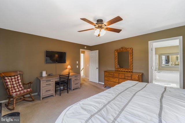 bedroom with a ceiling fan, baseboards, light colored carpet, and ensuite bathroom