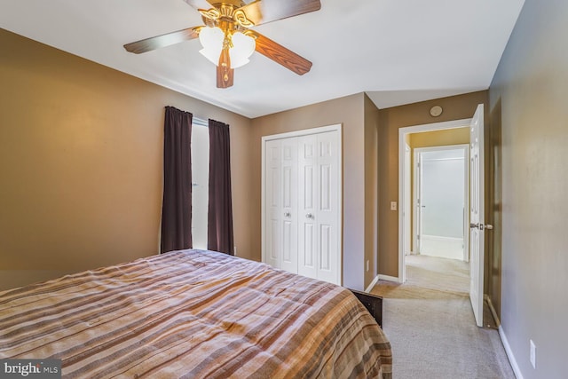 bedroom with a ceiling fan, carpet, a closet, and baseboards