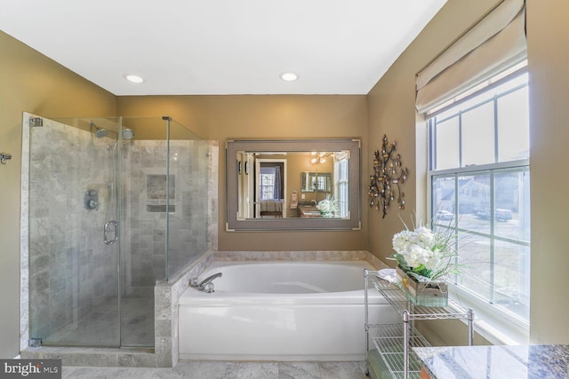 full bath featuring a shower stall, a bath, and a healthy amount of sunlight