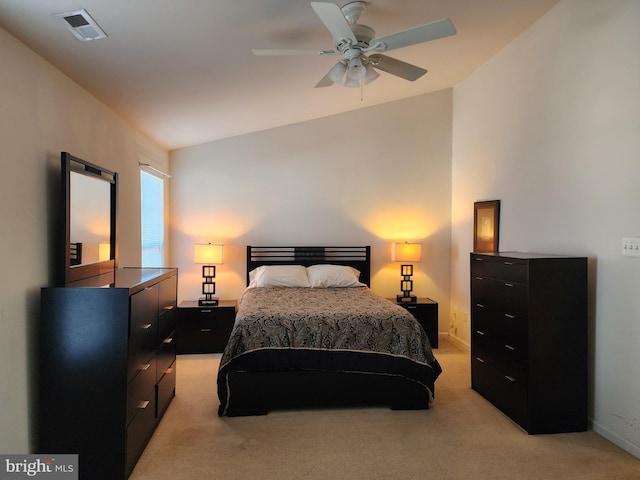 bedroom with visible vents, lofted ceiling, light colored carpet, and baseboards