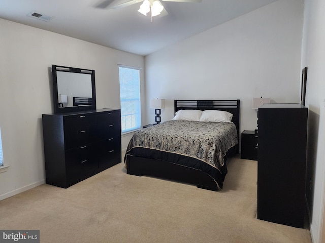 bedroom featuring visible vents, light colored carpet, a ceiling fan, and lofted ceiling