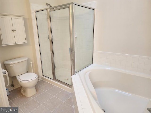 full bath featuring toilet, a shower stall, tile patterned flooring, baseboards, and a bath