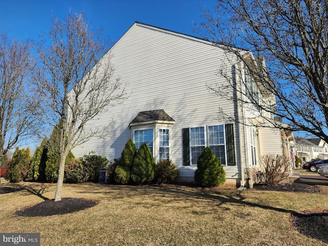 view of side of property featuring a yard