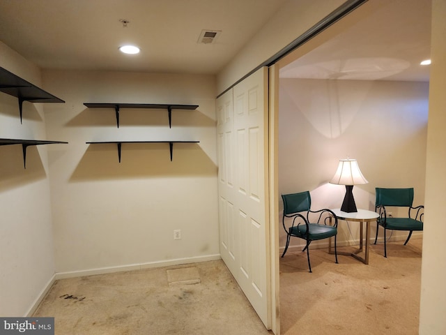 walk in closet with visible vents and carpet