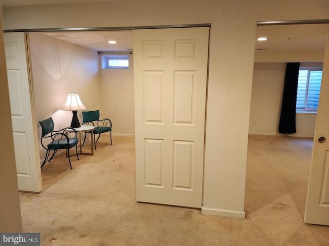 living area with baseboards and carpet flooring