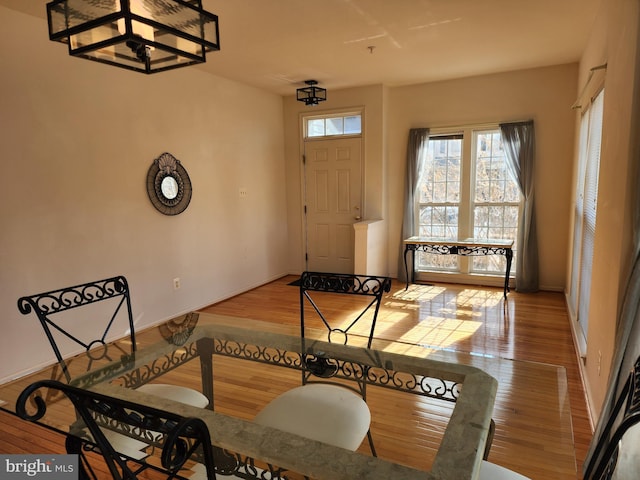 dining space featuring baseboards and wood finished floors