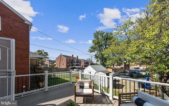 wooden deck with an outbuilding, a residential view, and fence