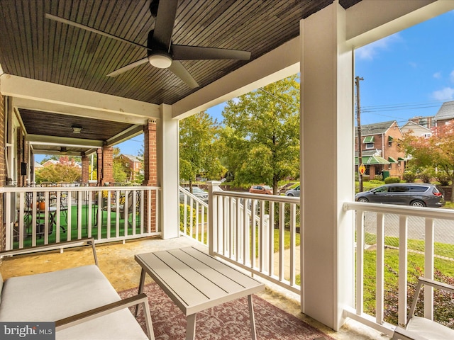 balcony featuring covered porch and a ceiling fan