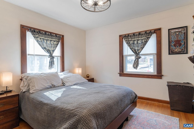 bedroom with baseboards and wood finished floors