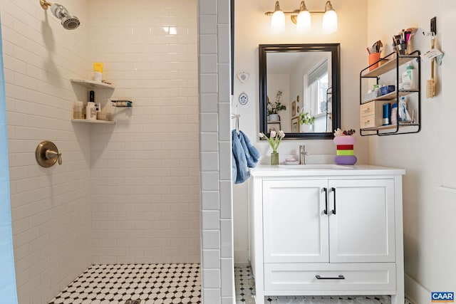 bathroom featuring vanity and tiled shower