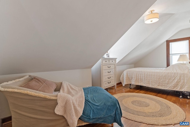 bedroom featuring vaulted ceiling and wood finished floors