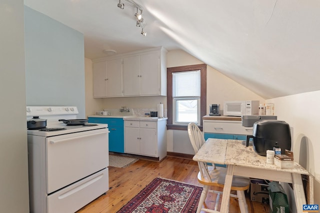 kitchen featuring light countertops, vaulted ceiling, light wood-style floors, white appliances, and white cabinetry