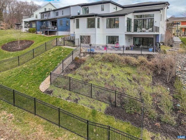 back of house featuring a patio, a fenced backyard, and a lawn