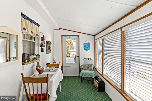 dining area featuring vaulted ceiling, carpet floors, and ornamental molding