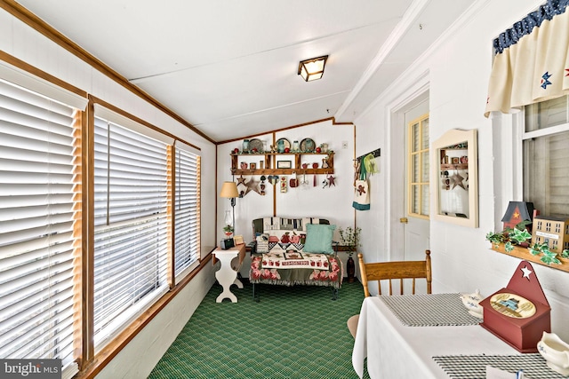 dining space featuring lofted ceiling, carpet flooring, and crown molding