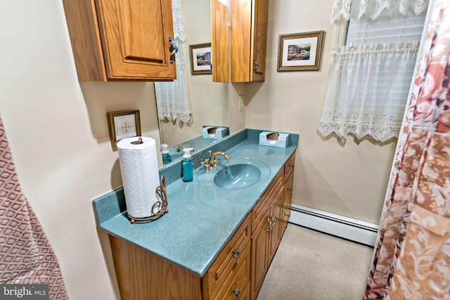 bathroom featuring baseboard heating and vanity