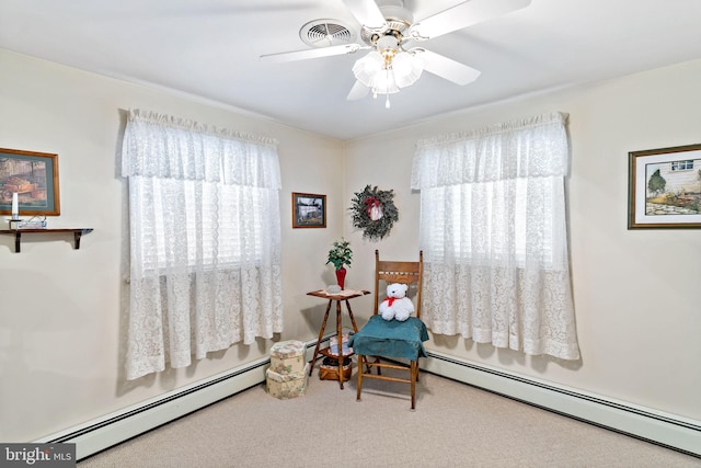 living area featuring visible vents, carpet floors, a baseboard heating unit, and a ceiling fan