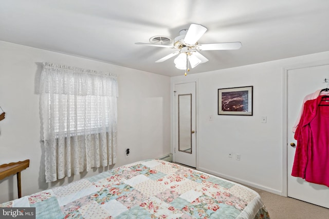 carpeted bedroom with a baseboard radiator and ceiling fan