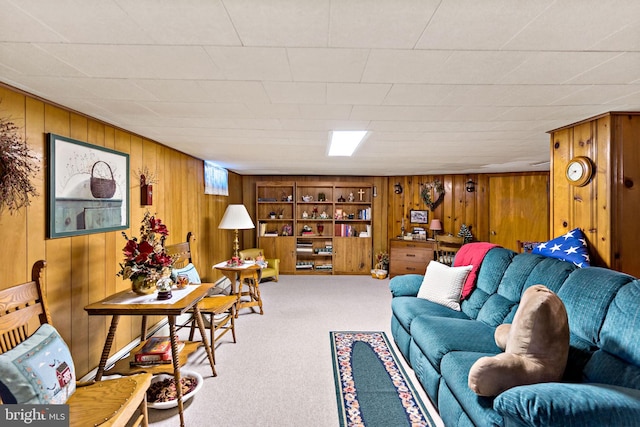 living room with wood walls and carpet flooring