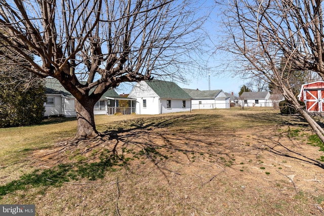 view of yard featuring an outdoor structure and fence