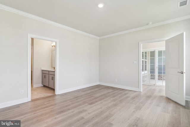 interior space featuring visible vents, light wood-style flooring, and ornamental molding