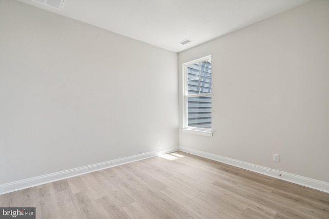 spare room featuring visible vents, baseboards, and light wood-style flooring