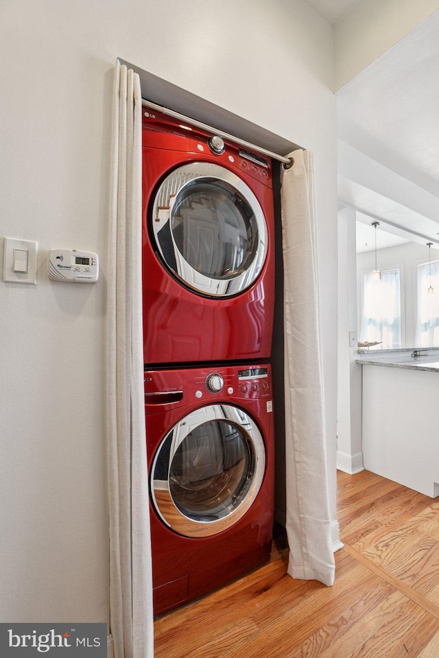 106 15th St SE, Washington, DC 20003 - washroom featuring stacked washing machine and dryer and wood finished floors
