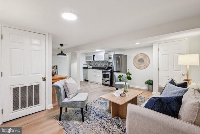 106 15th St SE, Washington, DC 20003 - living area featuring baseboards and light wood-type flooring