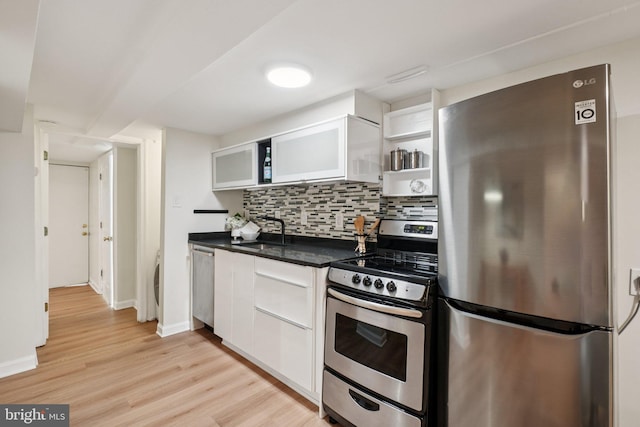 106 15th St SE, Washington, DC 20003 - kitchen featuring stainless steel appliances, open shelves, dark countertops, and white cabinets