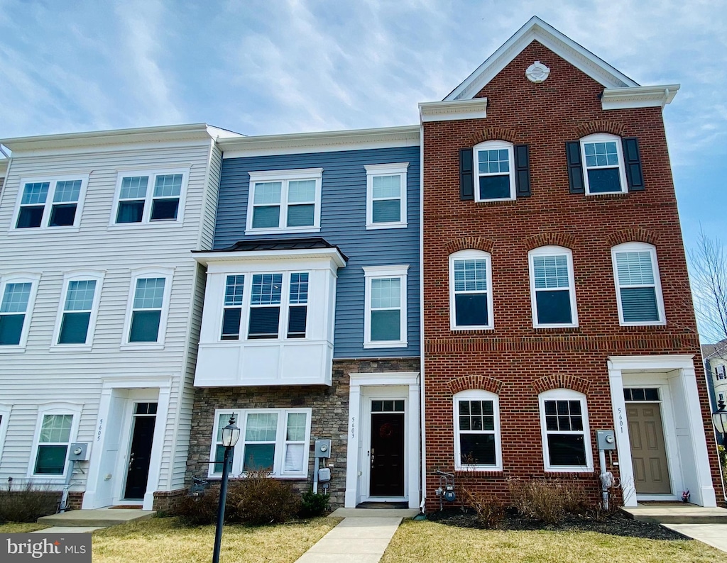 multi unit property featuring brick siding and stone siding