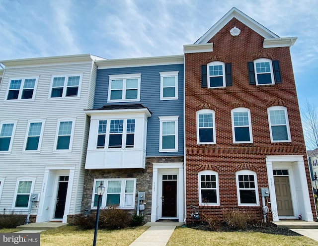 multi unit property with stone siding and brick siding