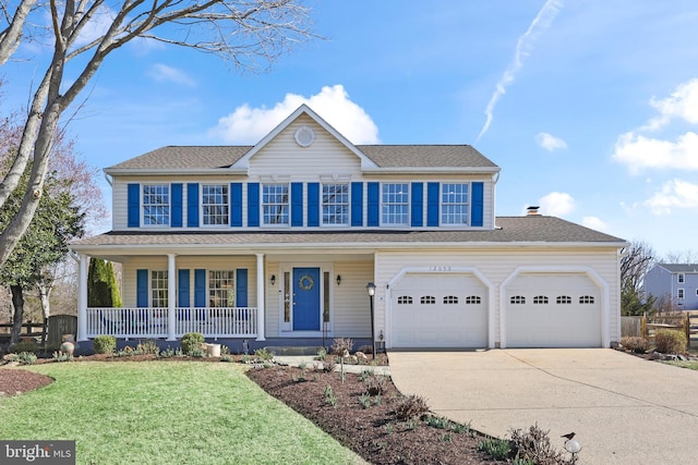 colonial house with covered porch, concrete driveway, a front lawn, and a shingled roof