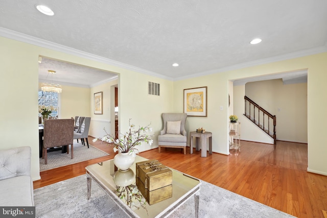 living room featuring visible vents, wood finished floors, recessed lighting, stairway, and crown molding