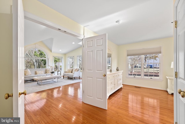 interior space with light wood finished floors, visible vents, recessed lighting, and lofted ceiling