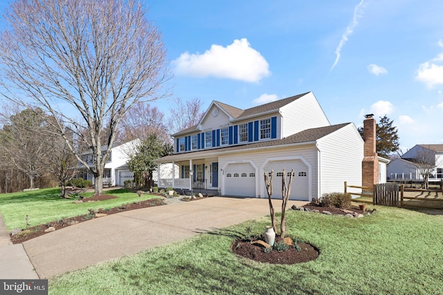 view of front of home featuring a front lawn, concrete driveway, and fence