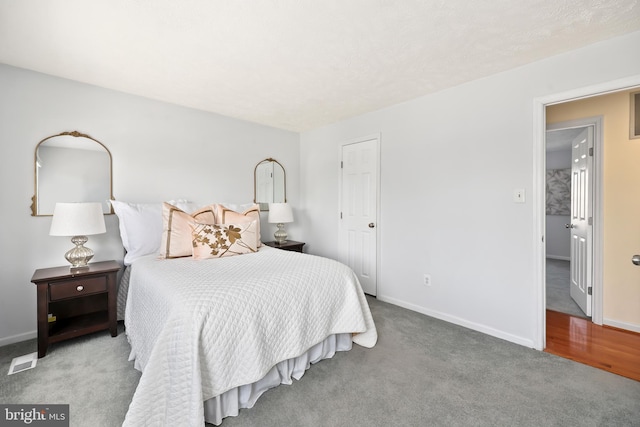 bedroom featuring visible vents, baseboards, and carpet floors