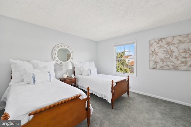 bedroom with baseboards, carpet floors, and a textured ceiling