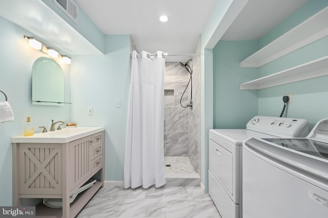 clothes washing area featuring visible vents, marble finish floor, a sink, laundry area, and washing machine and clothes dryer