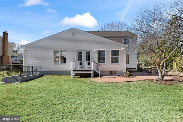 rear view of house featuring a patio, a lawn, and a deck