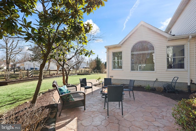 view of patio with an outdoor living space and fence