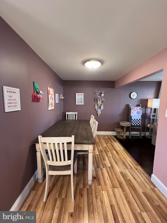 dining area with wood finished floors and baseboards