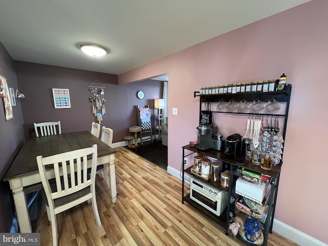 dining room featuring baseboards and wood finished floors