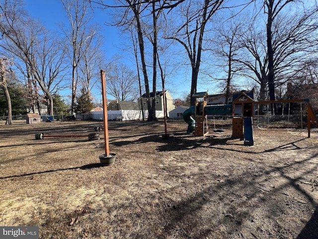 view of yard featuring fence and playground community