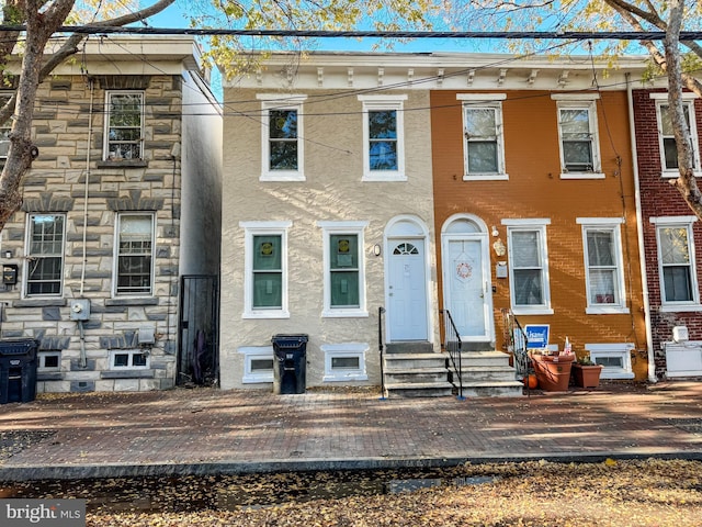 view of property featuring stone siding