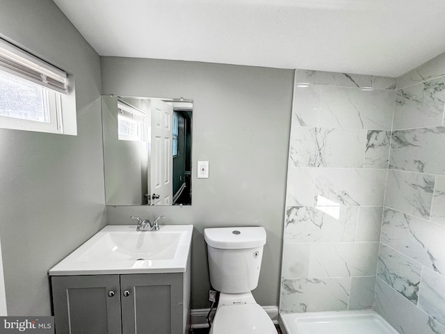 full bath featuring toilet, a shower stall, and vanity