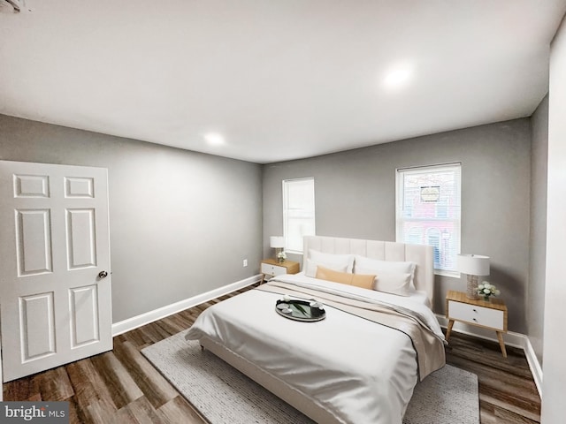 bedroom with baseboards and wood finished floors