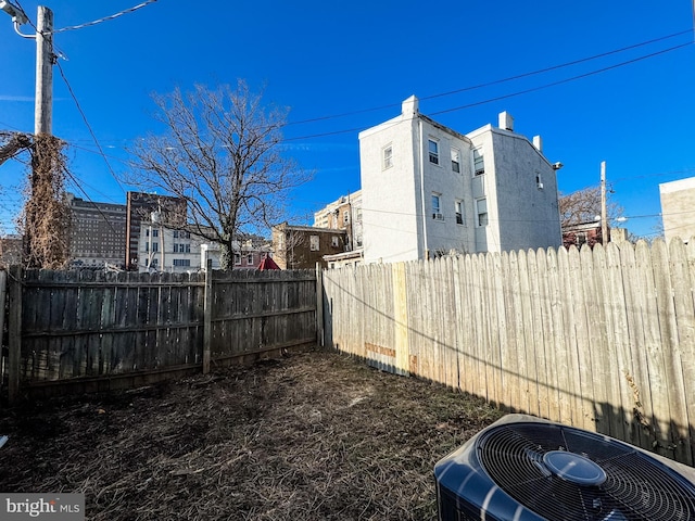 view of yard featuring central air condition unit and a fenced backyard