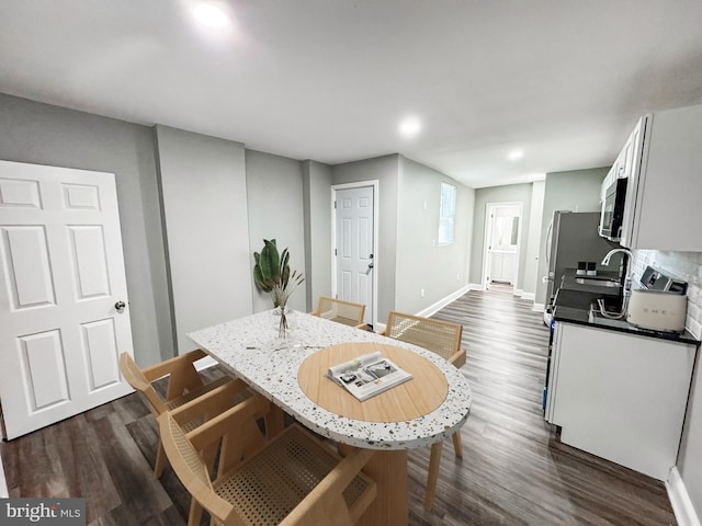 dining space with recessed lighting, baseboards, and dark wood-style flooring