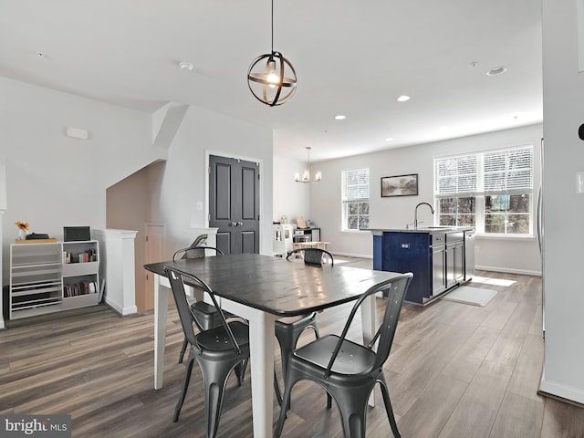 dining space featuring recessed lighting, baseboards, and wood finished floors